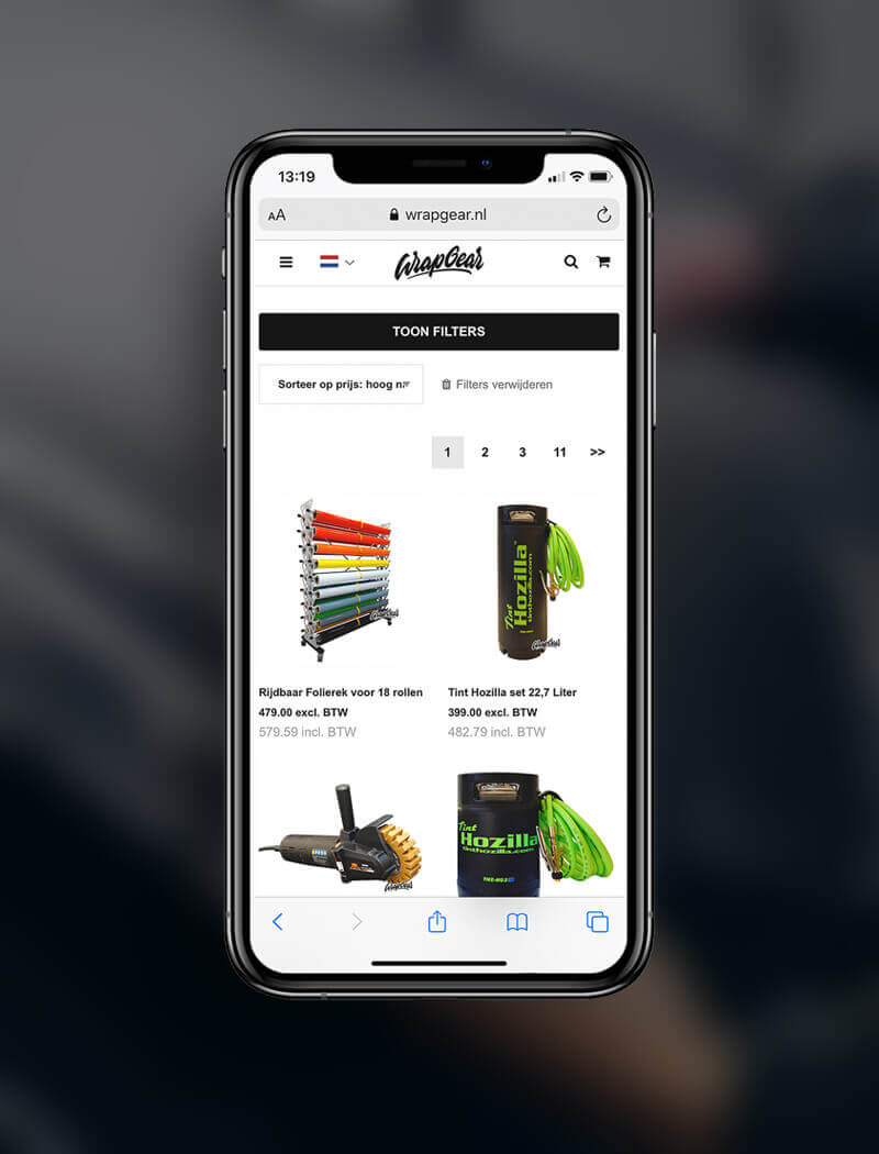Op een smartphone wordt de productpagina van Wrapgear.nl weergegeven, met daarop gereedschap, apparatuur, slangen en haspels.