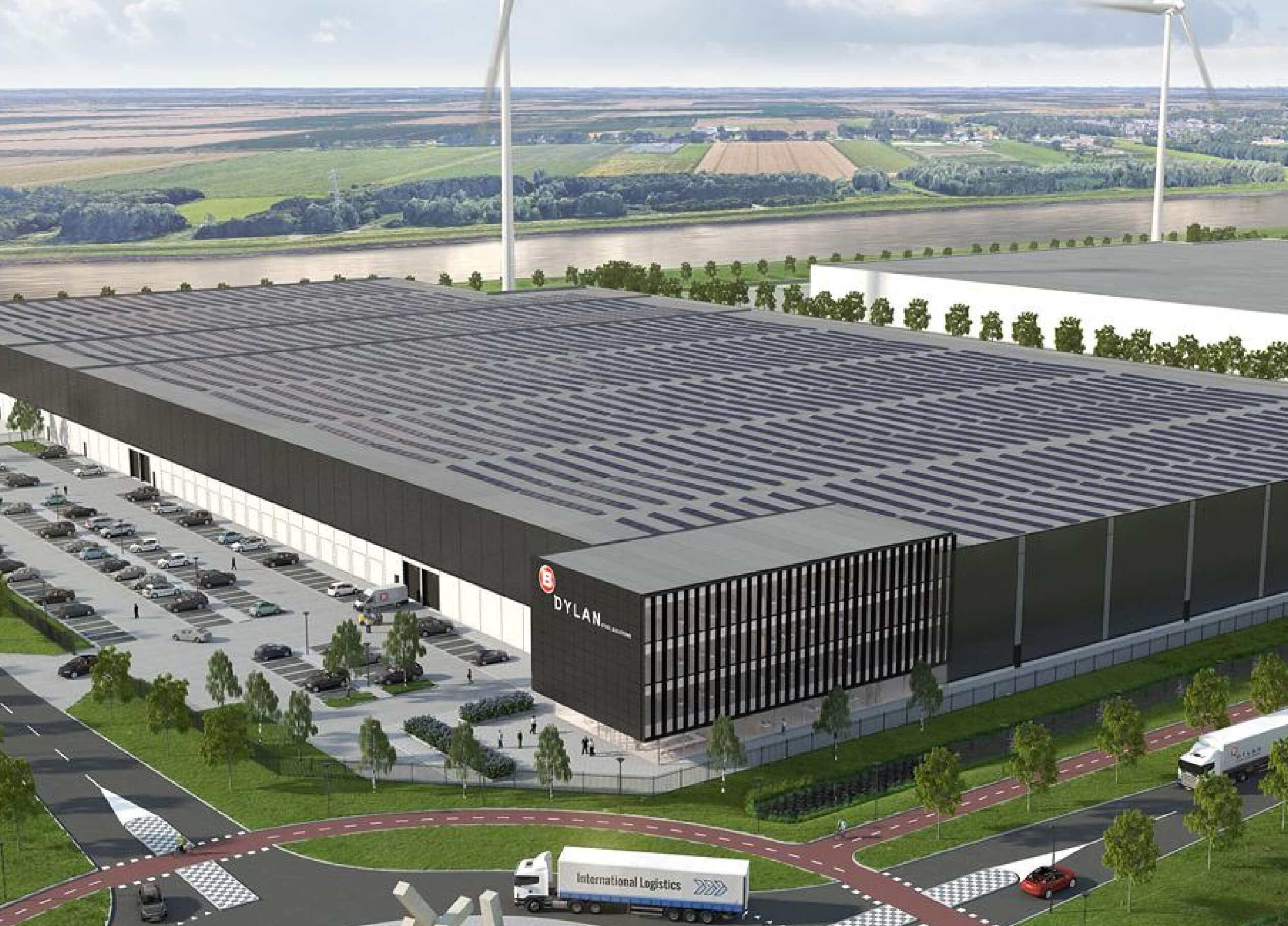 Het op zonne-energie werkende magazijn van Dylan Steel Solutions, te midden van groen en windturbines, van bovenaf vastgelegd.