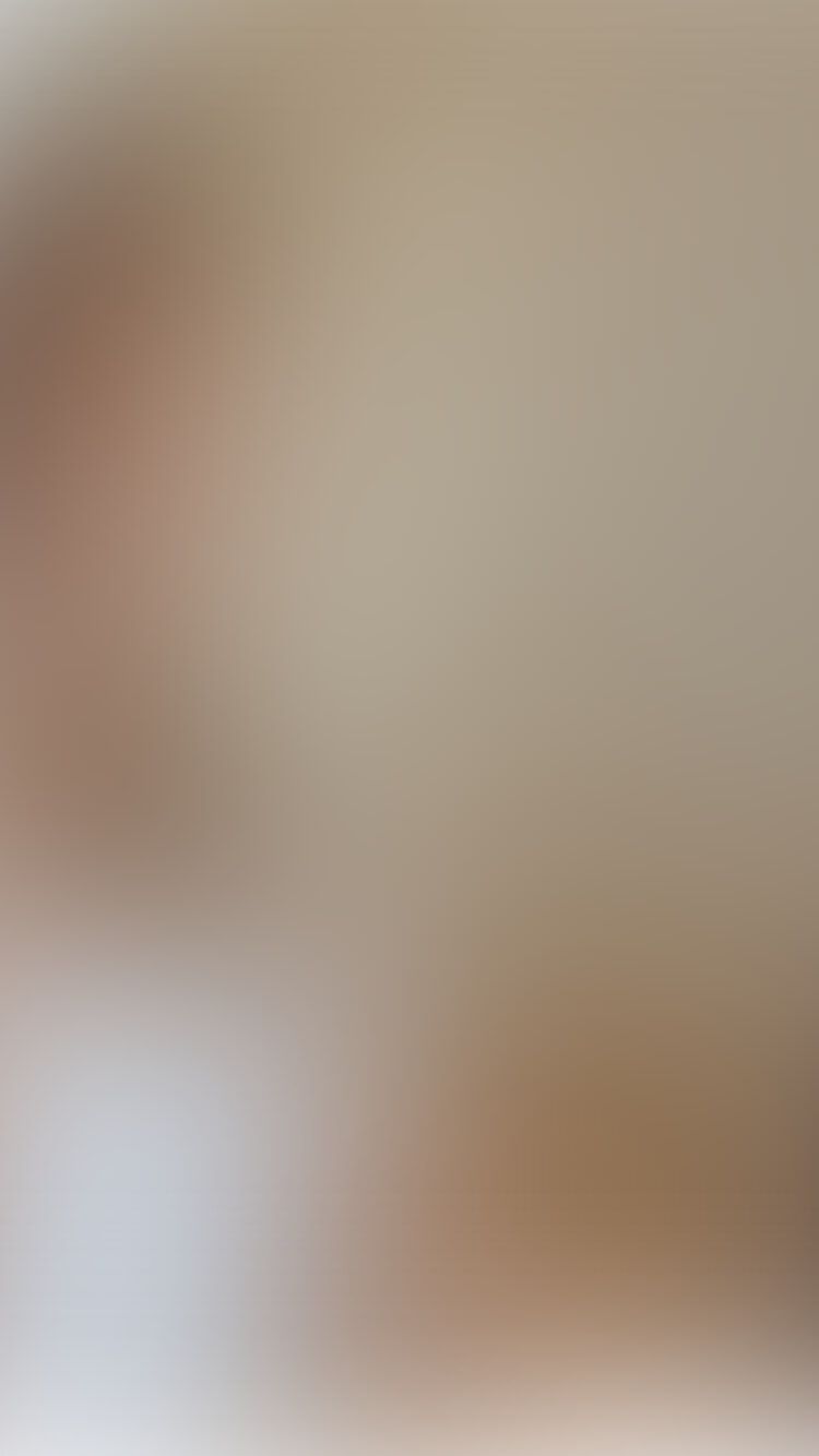 Onscherpe foto van iemand die binnenshuis aan een tafel zit.