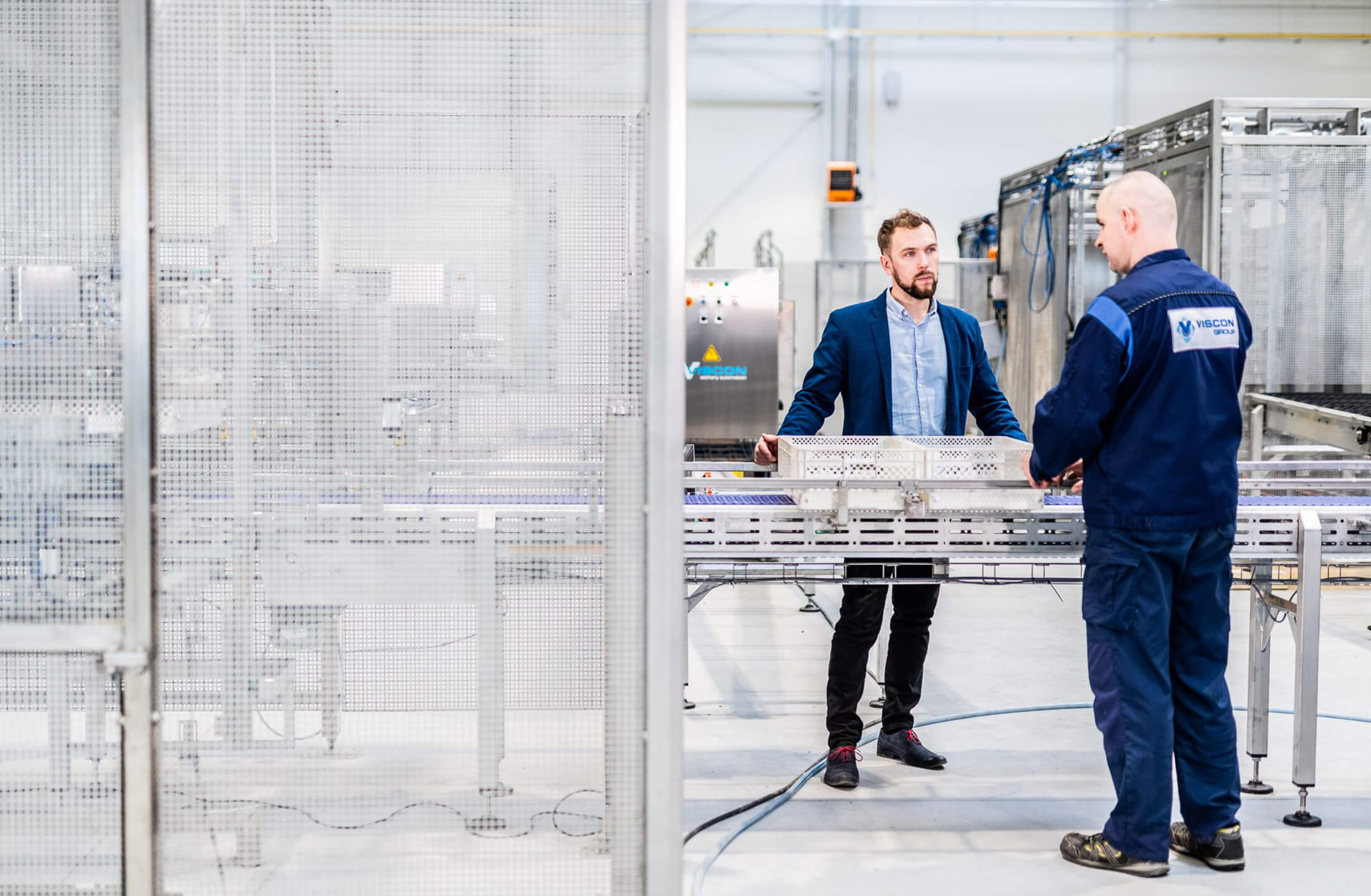 Twee mannen van Viscon Group bespreken innovatie in industriële metaalconstructies en machines.